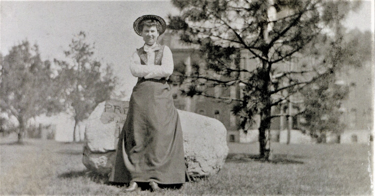 Willa Cather leans on an engraved boulder in front of University Hall; photo courtesy of University Archives and Special Collections