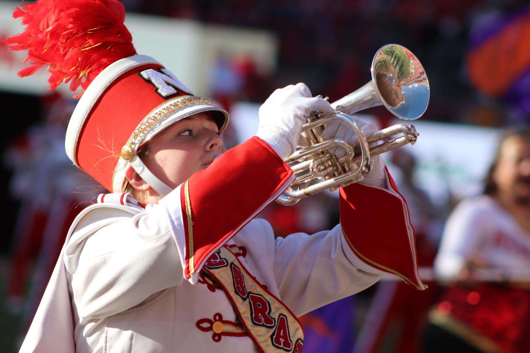 A photo of a Cornhusker Marching Band performing trumpet player.