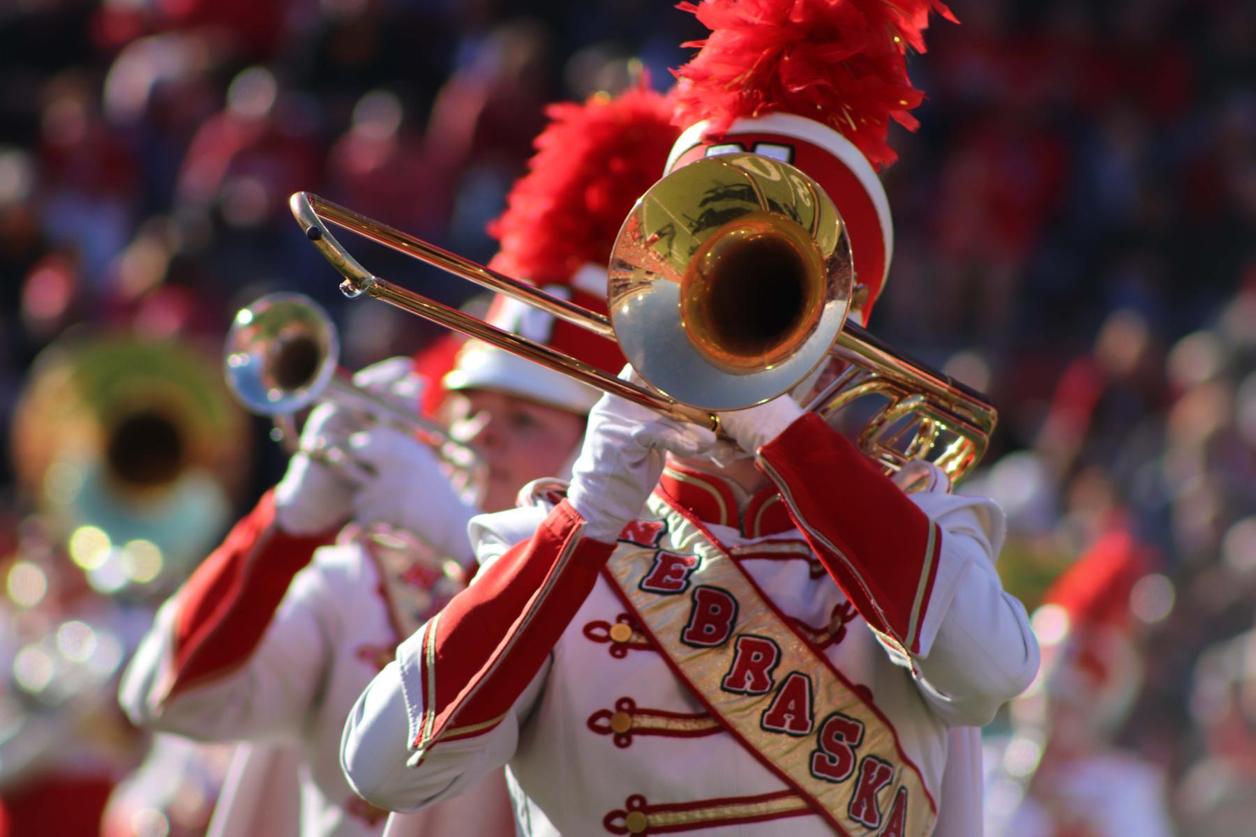 Cornhusker Marching Band trombone player performing in Memorial Stadium.