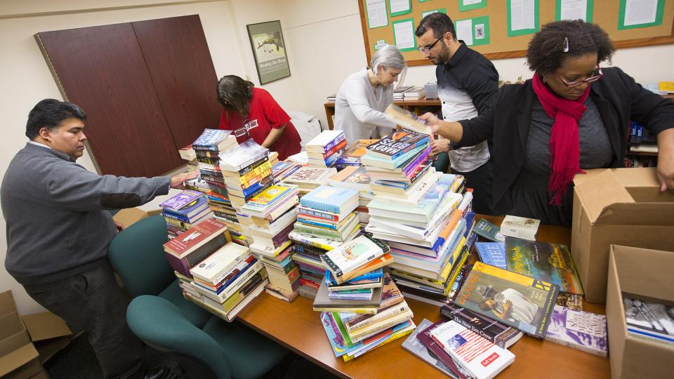 Students, faculty and staff from the Institute for Ethnic Studies organize books to send to Ferguson.; links to news story
