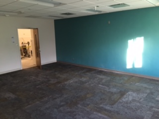 Renovated classroom with new carpet and teal accent wall