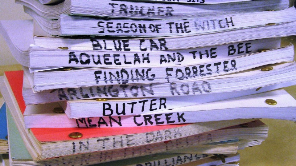 Stack of screenplays with titles showing; links to news story