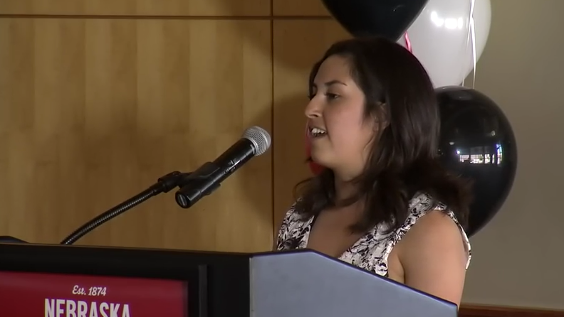 Jessica Vazquez speaks from the podium at this spring's celebration of excellence; links to news story