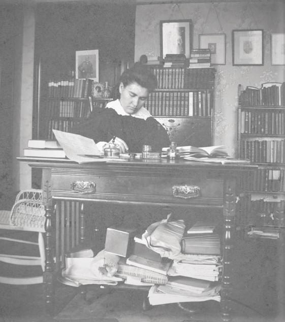 Willa Cather writing at a desk