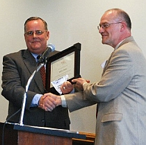 Robert Slauson receives award from Robert Brooke