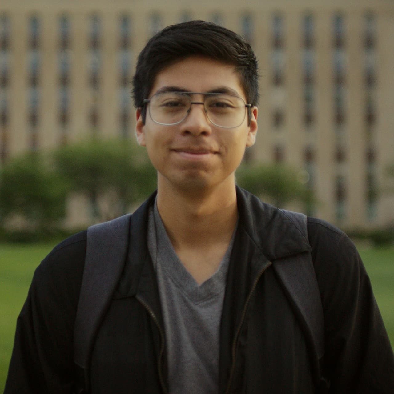 Student wearing backpack standing in front of Love Library