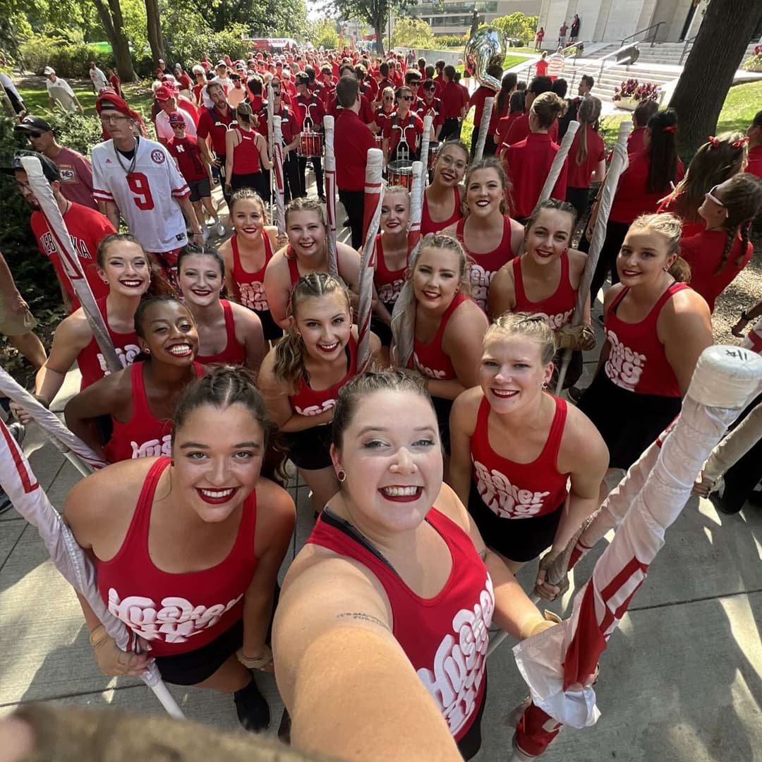 Members of the Cornhusker Marching Band Flag Line take a selfie.