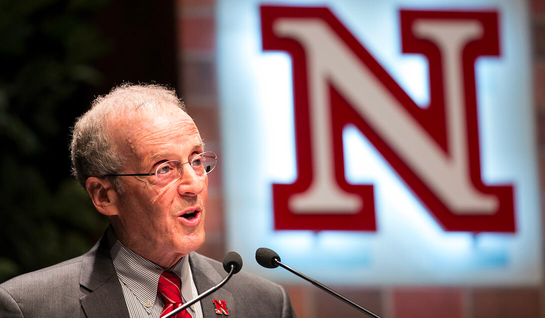 Former Chancellor Harvey Perlman speaking in front of N with glowing background