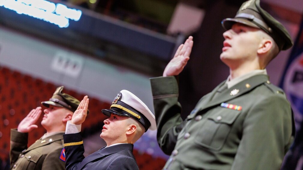 Three members of the University of Nebraska–Lincoln&#039;s Reserve Officer Training Corps, in uniform, recite the oath of enlistment during the undergraduate commencement ceremony Dec. 21 at Pinnacle Bank Arena.