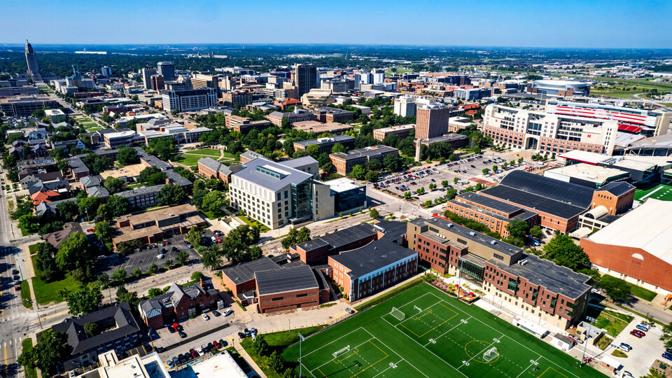 Aerial image of campus facing south including state capitol building in distance