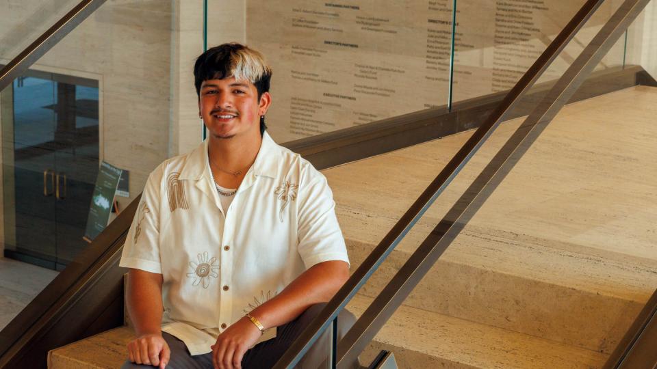 Student sitting on stairs at Sheldon Museum of Art